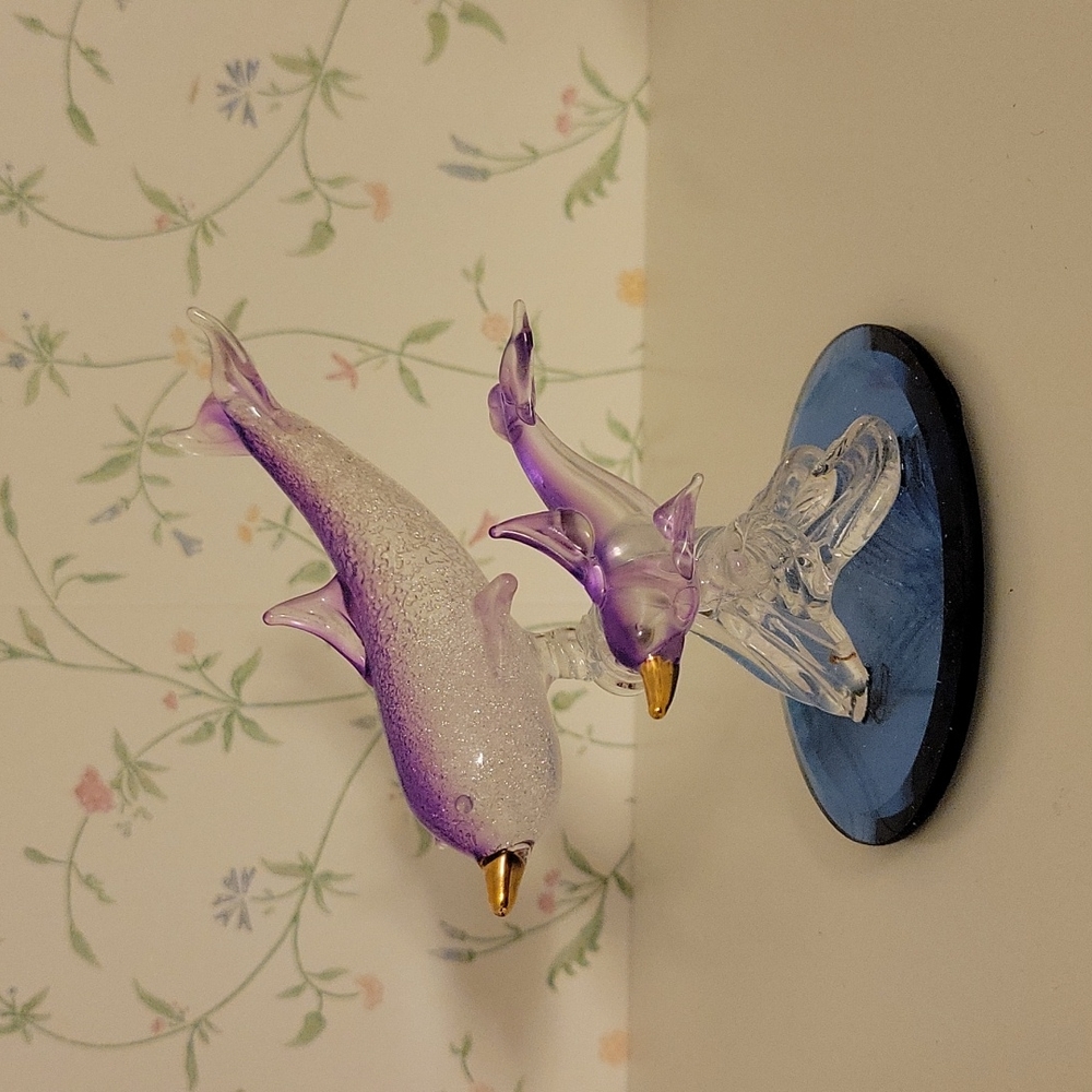 Two glass dolphin figurines